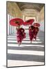 Myanmar, Mandalay Division, Bagan. Three Novice Monks Running with Red Umbrellas in a Walkway (Mr)-Matteo Colombo-Mounted Photographic Print