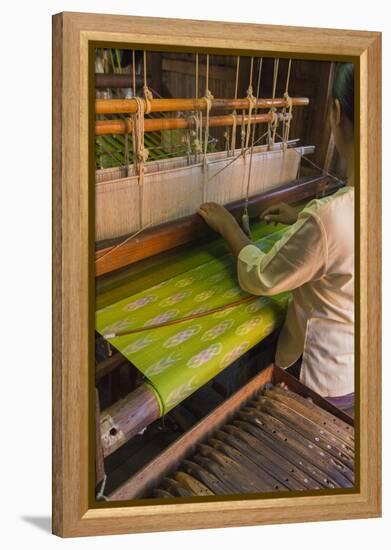 Myanmar. Shan State. Inle Lake. Woman weaving silk at a wooden loom.-Inger Hogstrom-Framed Premier Image Canvas