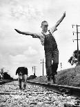 Larry Jim Holm with Dunk, His Spaniel Collie Mix, Walking Rail of Railroad Tracks in Rural Area-Myron Davis-Photographic Print