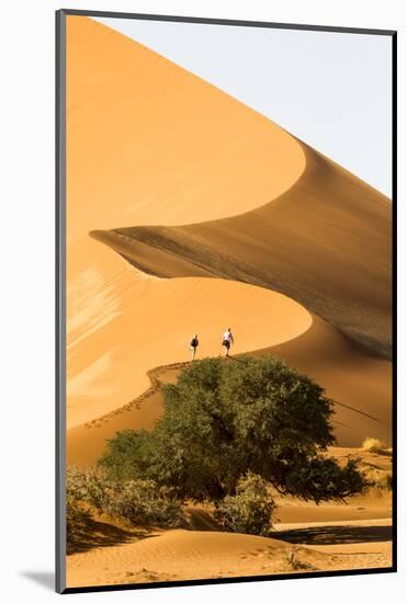 Namibia, Namib-Naukluft National Park, Sossusvlei. Two tourists climbing the scenic dune.-Ellen Goff-Mounted Photographic Print