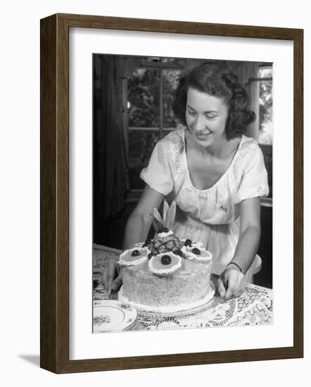 Nancy Drooling over a Pineapple Cake-Nina Leen-Framed Photographic Print