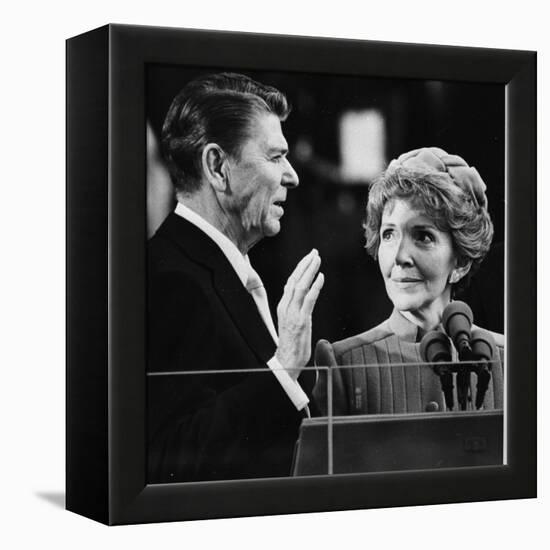 Nancy Reagan Proudly Watches as Her Husband Ronald Reagan Takes the Oath of Office-null-Framed Premier Image Canvas