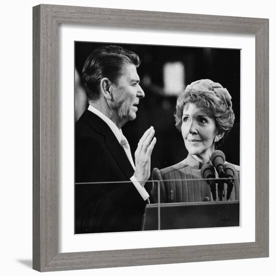 Nancy Reagan Proudly Watches as Her Husband Ronald Reagan Takes the Oath of Office-null-Framed Photographic Print