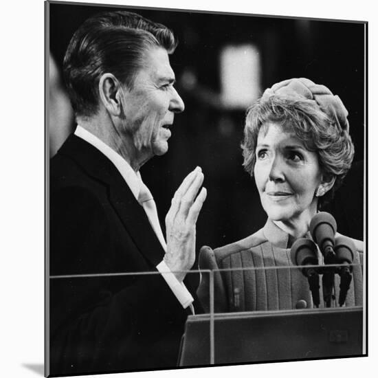 Nancy Reagan Proudly Watches as Her Husband Ronald Reagan Takes the Oath of Office-null-Mounted Photographic Print