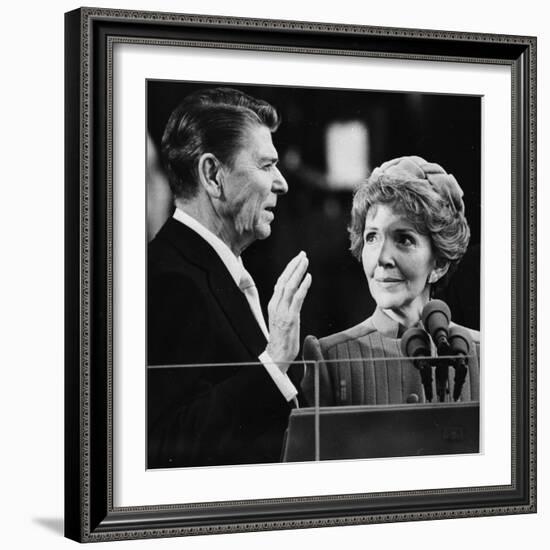 Nancy Reagan Proudly Watches as Her Husband Ronald Reagan Takes the Oath of Office-null-Framed Photographic Print