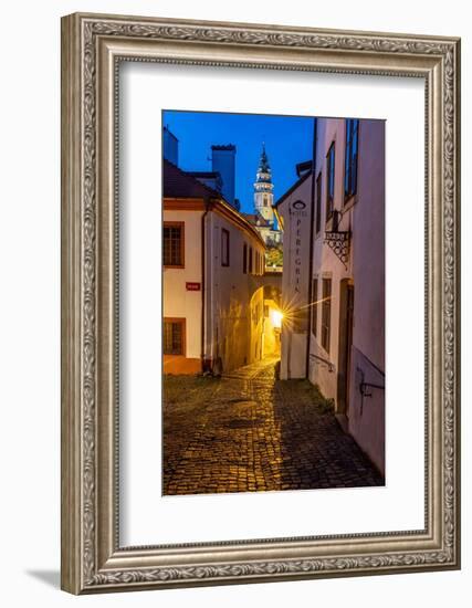 Narrow cobblestone streets at dusk with Castle Tower in historic Cesky Krumlov, Czech Republic.-Chuck Haney-Framed Photographic Print