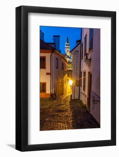 Narrow cobblestone streets at dusk with Castle Tower in historic Cesky Krumlov, Czech Republic.-Chuck Haney-Framed Photographic Print