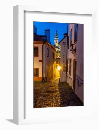 Narrow cobblestone streets at dusk with Castle Tower in historic Cesky Krumlov, Czech Republic.-Chuck Haney-Framed Photographic Print