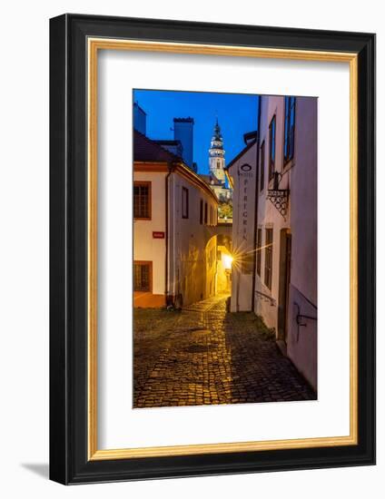 Narrow cobblestone streets at dusk with Castle Tower in historic Cesky Krumlov, Czech Republic.-Chuck Haney-Framed Photographic Print