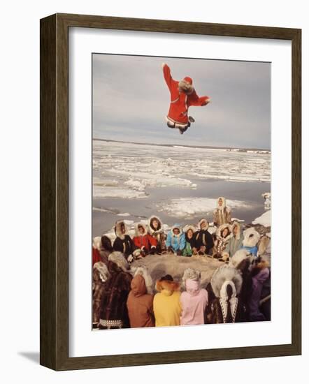 Native Alaskans Playing a Game of Nulukatuk, in Which Individals are Tossed into the Air-Ralph Crane-Framed Photographic Print