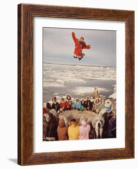 Native Alaskans Playing a Game of Nulukatuk, in Which Individals are Tossed into the Air-Ralph Crane-Framed Photographic Print