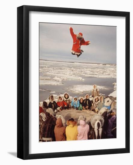 Native Alaskans Playing a Game of Nulukatuk, in Which Individals are Tossed into the Air-Ralph Crane-Framed Photographic Print