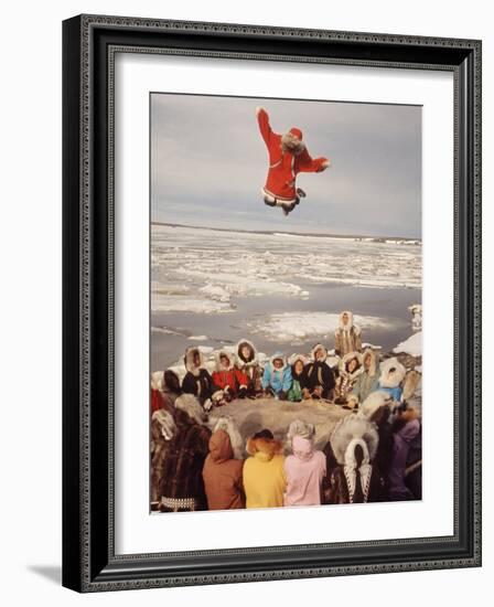 Native Alaskans Playing a Game of Nulukatuk, in Which Individals are Tossed into the Air-Ralph Crane-Framed Photographic Print