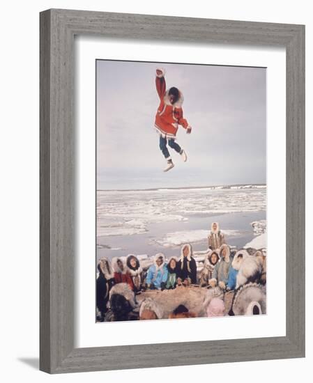 Native Alaskans Playing a Game of Nulukatuk, in Which Individals are Tossed into the Air-Ralph Crane-Framed Photographic Print