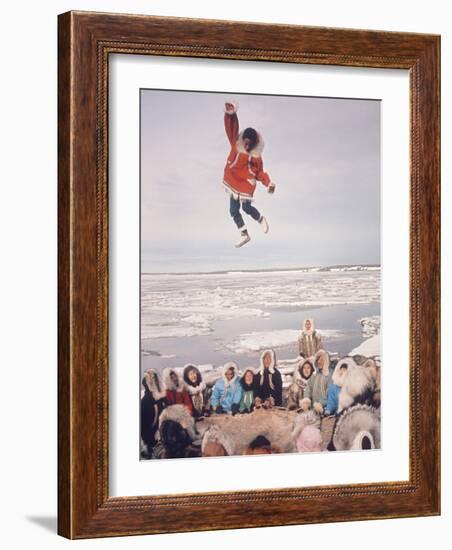 Native Alaskans Playing a Game of Nulukatuk, in Which Individals are Tossed into the Air-Ralph Crane-Framed Photographic Print