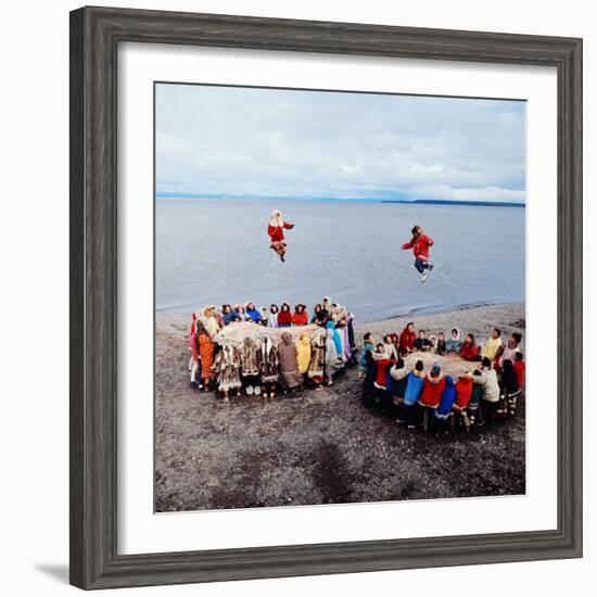 Native Alaskans Playing a Game of Nulukatuk, in Which Individals are Tossed into the Air-Ralph Crane-Framed Photographic Print