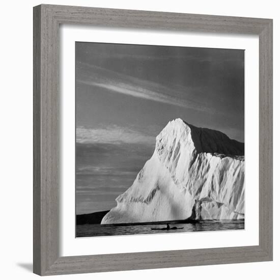 Native Man in Kayak Sitting in Water Next to Iceberg-null-Framed Photographic Print