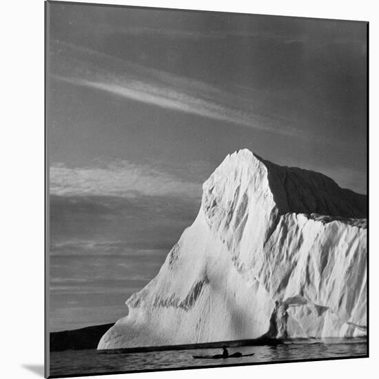 Native Man in Kayak Sitting in Water Next to Iceberg-null-Mounted Photographic Print