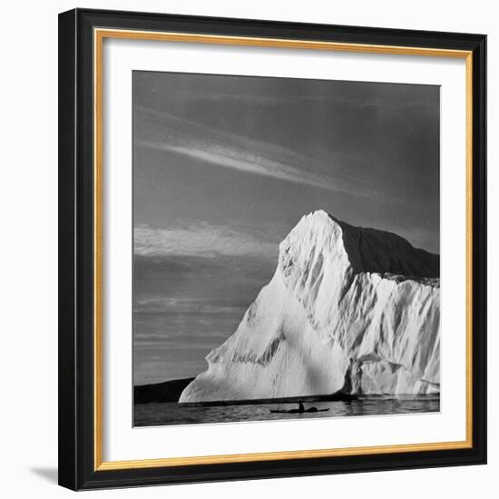 Native Man in Kayak Sitting in Water Next to Iceberg-null-Framed Photographic Print