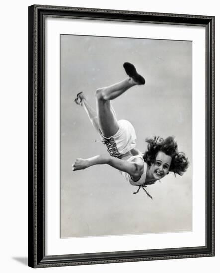 Natl. Women's Tumbling Champion, 15 Year Old, Bonnie Nebelong, in Mid Air with Legs Akimbo-Gjon Mili-Framed Photographic Print