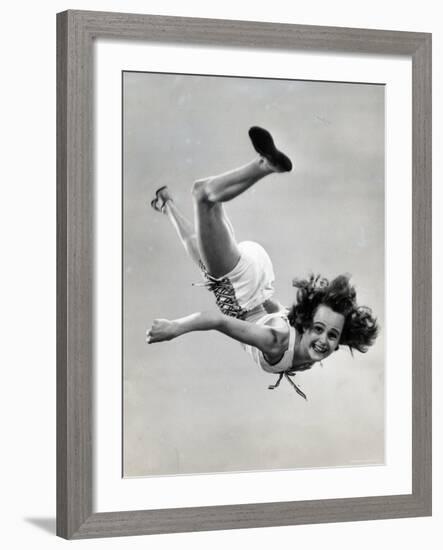 Natl. Women's Tumbling Champion, 15 Year Old, Bonnie Nebelong, in Mid Air with Legs Akimbo-Gjon Mili-Framed Photographic Print
