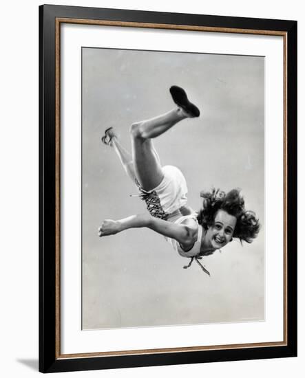 Natl. Women's Tumbling Champion, 15 Year Old, Bonnie Nebelong, in Mid Air with Legs Akimbo-Gjon Mili-Framed Photographic Print