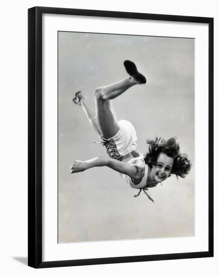 Natl. Women's Tumbling Champion, 15 Year Old, Bonnie Nebelong, in Mid Air with Legs Akimbo-Gjon Mili-Framed Photographic Print