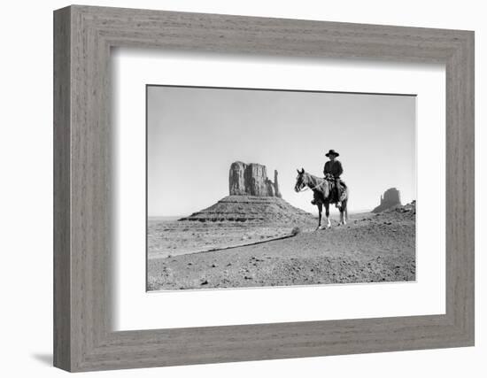 NAVAJO INDIAN IN COWBOY HAT ON HORSEBACK WITH MONUMENT VALLEY ROCK FORMATIONS IN BACKGROUND-D Corson-Framed Photographic Print