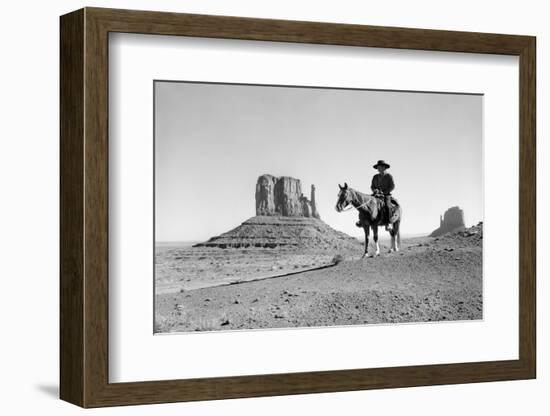 NAVAJO INDIAN IN COWBOY HAT ON HORSEBACK WITH MONUMENT VALLEY ROCK FORMATIONS IN BACKGROUND-D Corson-Framed Photographic Print