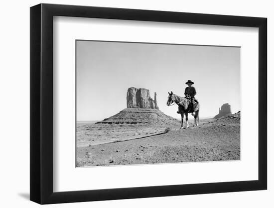 NAVAJO INDIAN IN COWBOY HAT ON HORSEBACK WITH MONUMENT VALLEY ROCK FORMATIONS IN BACKGROUND-D Corson-Framed Photographic Print