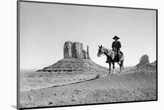 NAVAJO INDIAN IN COWBOY HAT ON HORSEBACK WITH MONUMENT VALLEY ROCK FORMATIONS IN BACKGROUND-D Corson-Mounted Photographic Print