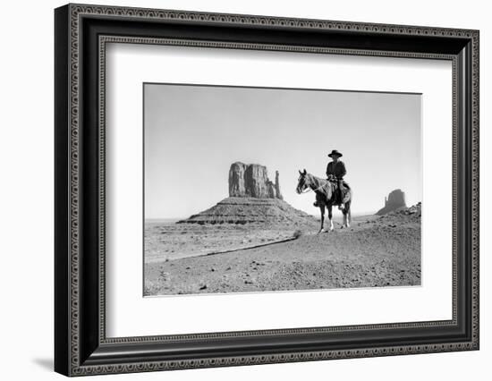 NAVAJO INDIAN IN COWBOY HAT ON HORSEBACK WITH MONUMENT VALLEY ROCK FORMATIONS IN BACKGROUND-D Corson-Framed Photographic Print