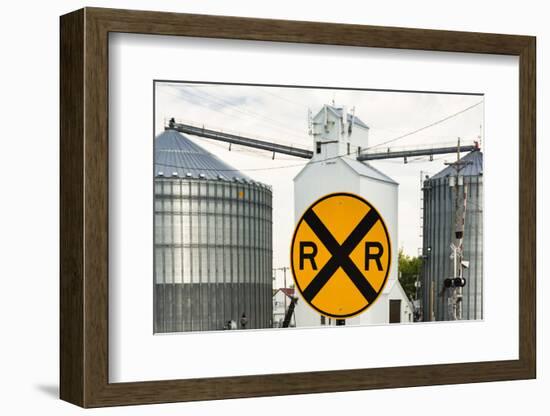 Nebraska, Blair, Washington County. Grain silo and equipment on Front Street, RR crossing sign.-Alison Jones-Framed Photographic Print