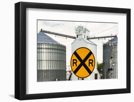 Nebraska, Blair, Washington County. Grain silo and equipment on Front Street, RR crossing sign.-Alison Jones-Framed Photographic Print