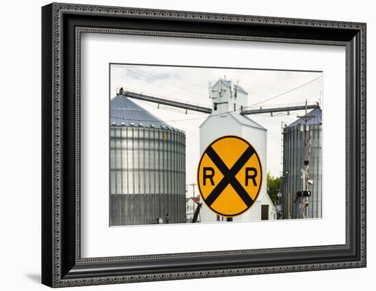 Nebraska, Blair, Washington County. Grain silo and equipment on Front Street, RR crossing sign.-Alison Jones-Framed Photographic Print