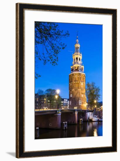 Netherlands, North Holland, Amsterdam. 16th century Montelbaanstoren tower on Oudeschans canal.-Jason Langley-Framed Photographic Print