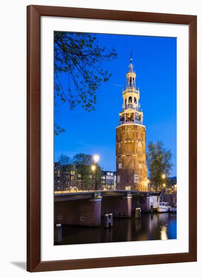 Netherlands, North Holland, Amsterdam. 16th century Montelbaanstoren tower on Oudeschans canal.-Jason Langley-Framed Photographic Print