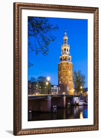 Netherlands, North Holland, Amsterdam. 16th century Montelbaanstoren tower on Oudeschans canal.-Jason Langley-Framed Photographic Print