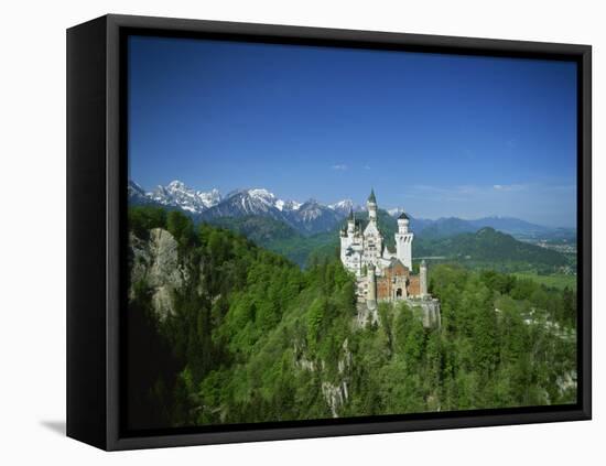 Neuschwanstein Castle on a Wooded Hill with Mountains in the Background, in Bavaria, Germany-null-Framed Premier Image Canvas