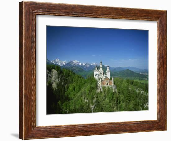 Neuschwanstein Castle on a Wooded Hill with Mountains in the Background, in Bavaria, Germany-null-Framed Photographic Print