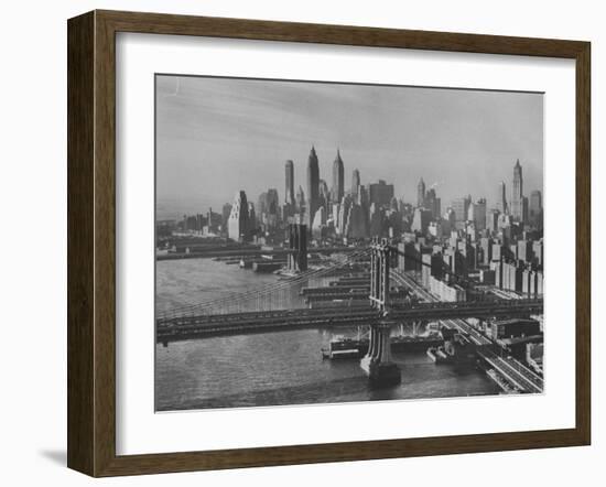 New York City Behind the Brooklyn and Manhattan Bridges That are Hovering over the East River-Dmitri Kessel-Framed Photographic Print