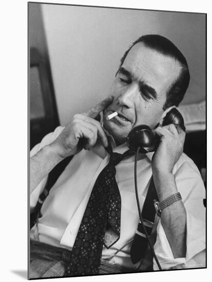 News Commentator, Edward R. Murrow with cigarette in mouth, tie loose, resting in his chair-Lisa Larsen-Mounted Premium Photographic Print