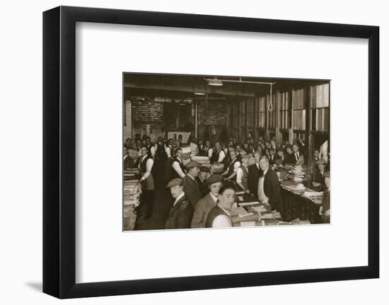 Newsvendors gather to pick up the next day's newspapers to sell, Carmelite House, 20th century-Unknown-Framed Photographic Print