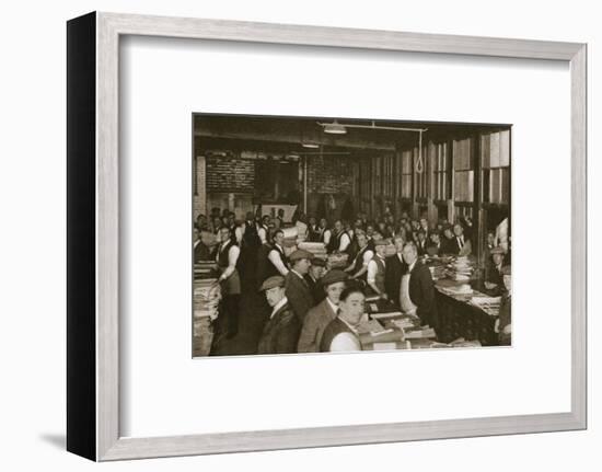 Newsvendors gather to pick up the next day's newspapers to sell, Carmelite House, 20th century-Unknown-Framed Photographic Print