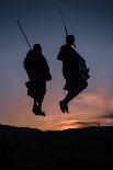 Two Masaai Warriors Silhouetted Performing Traditional Jump - Leap Kopje at Sunset-Nick Garbutt-Photographic Print