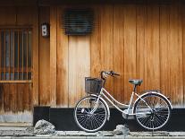 Japan, Chubu Region, Kyoto, Gion, a Bicycle Rests Against the Wall of a Traditional Building-Nick Ledger-Photographic Print