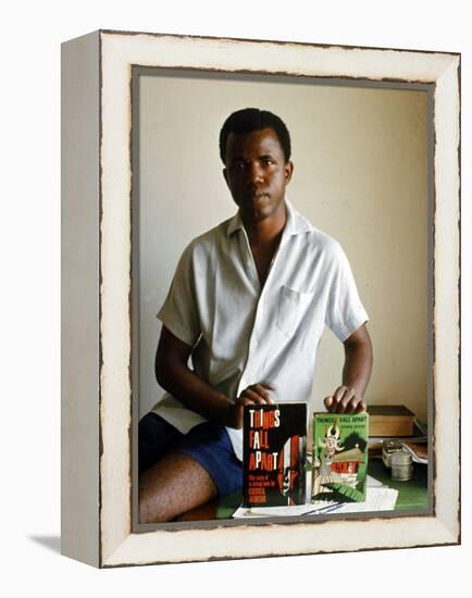 Nigerian Author Chinua Achebe Holding Two Editions of His Book Things Fall Apart-Eliot Elisofon-Framed Premier Image Canvas