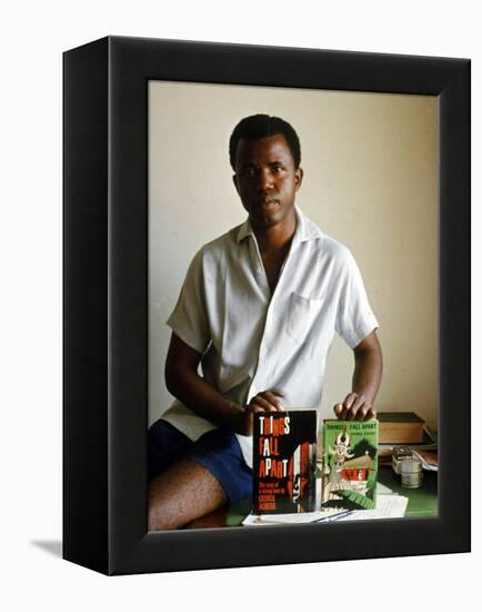 Nigerian Author Chinua Achebe Holding Two Editions of His Book Things Fall Apart-Eliot Elisofon-Framed Premier Image Canvas