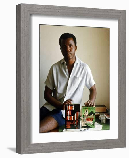 Nigerian Author Chinua Achebe Holding Two Editions of His Book Things Fall Apart-Eliot Elisofon-Framed Premium Photographic Print