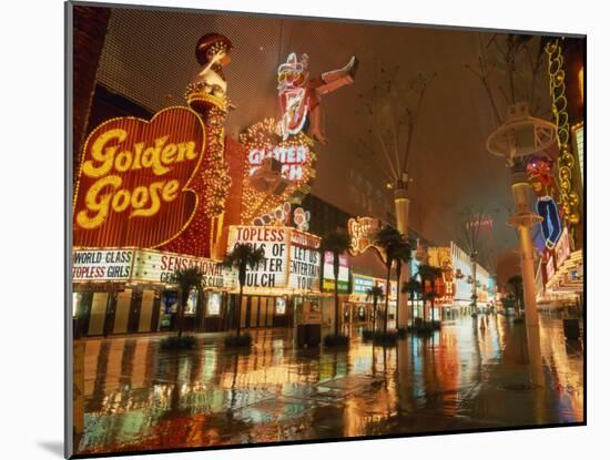 Night Reflections on Wet Street of Neon Signs Along Fremont Street in Las Vegas, Nevada, USA-null-Mounted Photographic Print